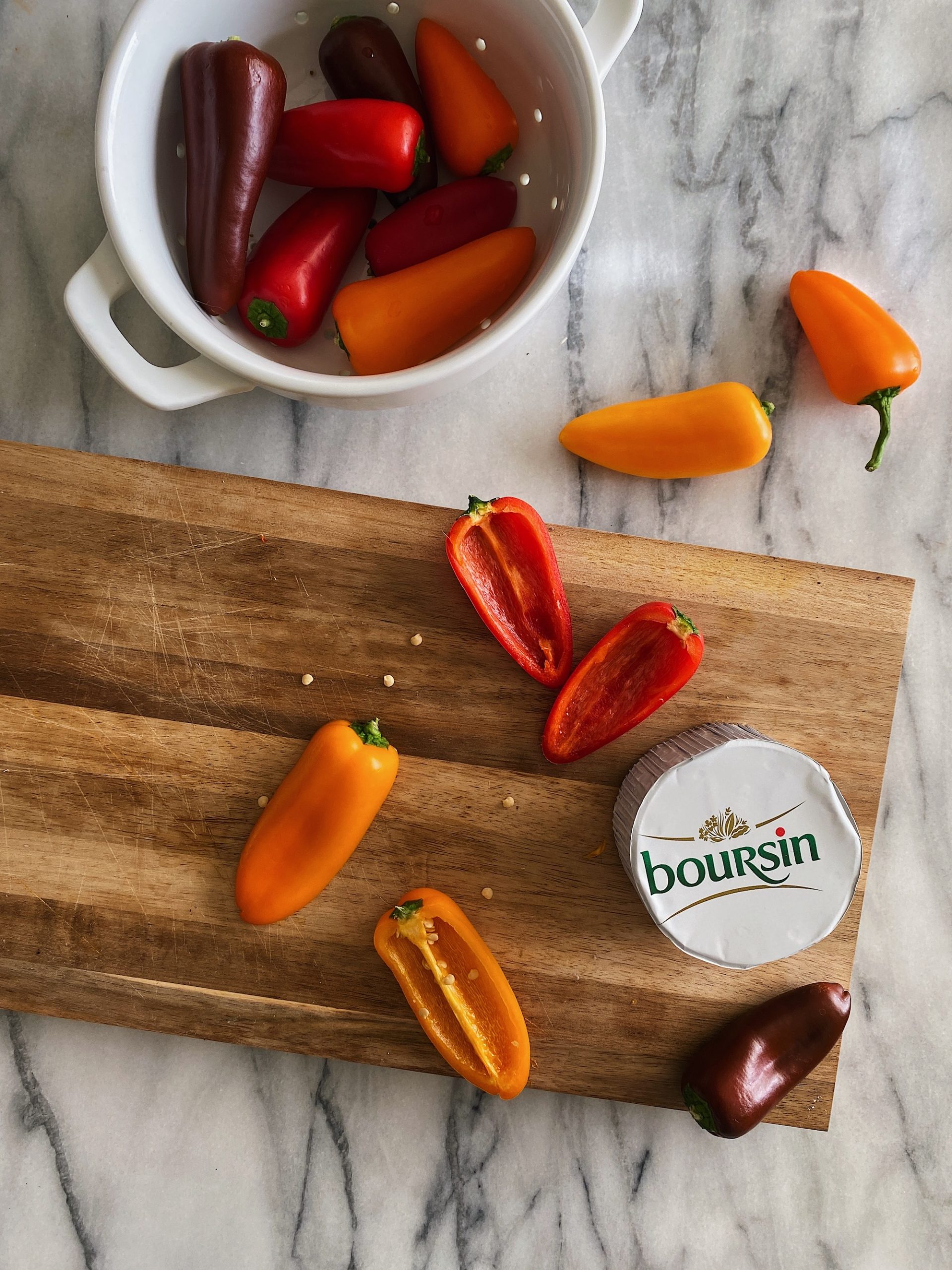 boursin and mini bell peppers on a cutting board