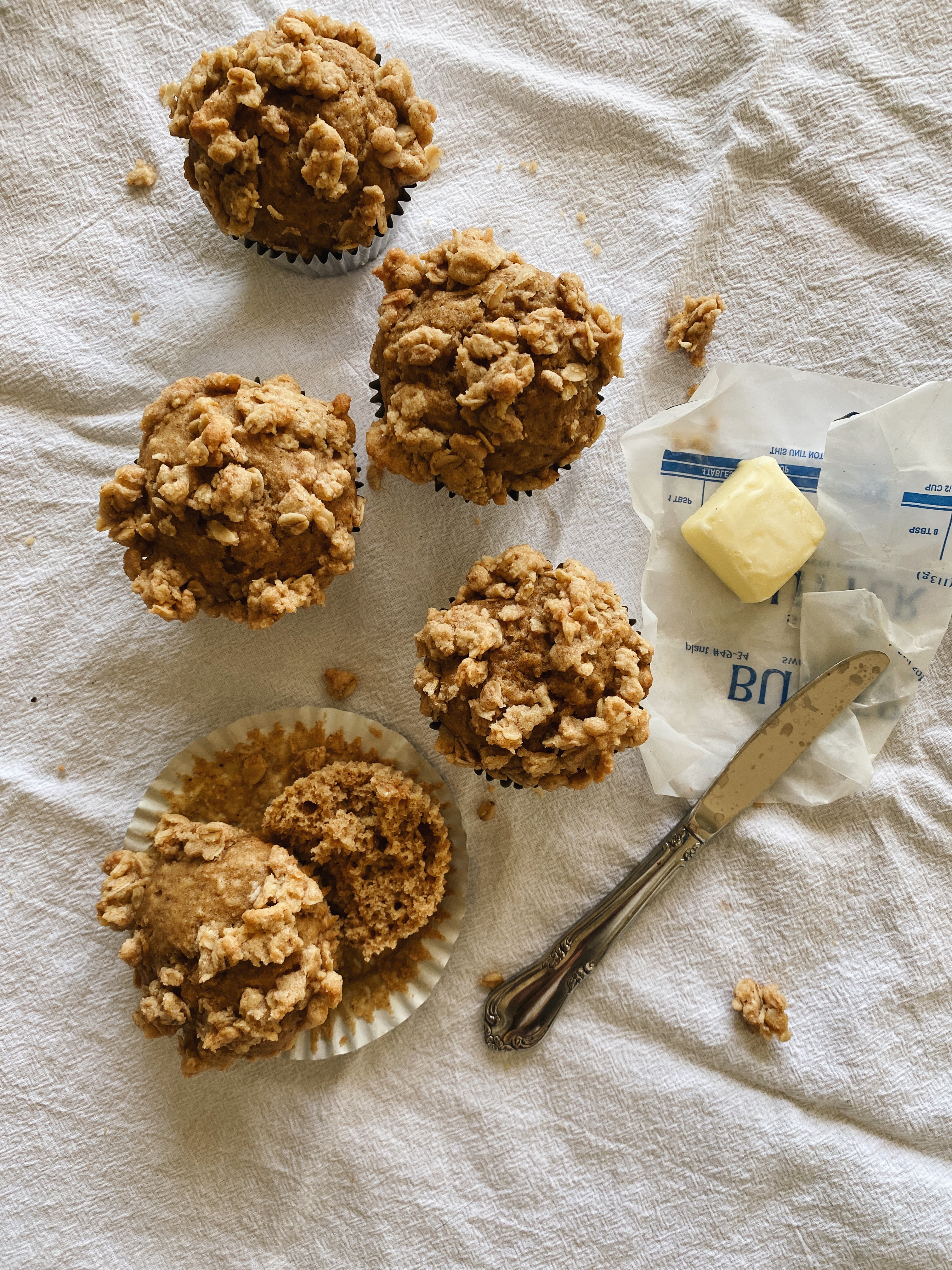 spiced applesauce crumble muffins with butter